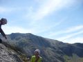 Andy Teasdale (BMG) short rope practice in North Wales, Idwal slabs behind him.